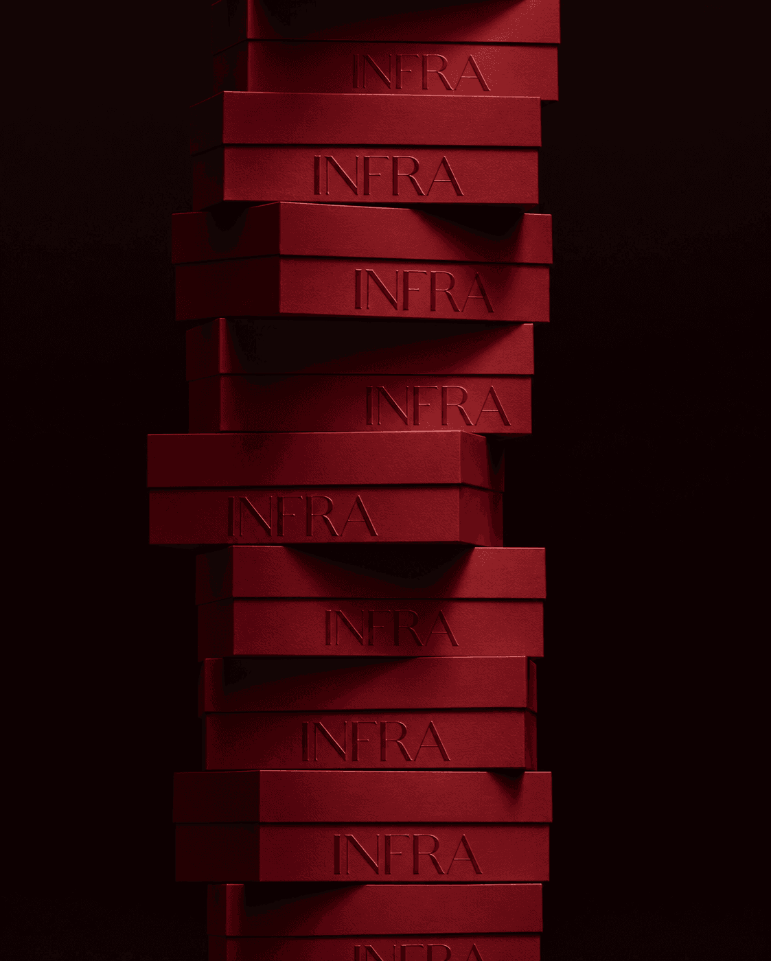 Stack of lacquered cherry INFRA gift boxes, embossed wordmark