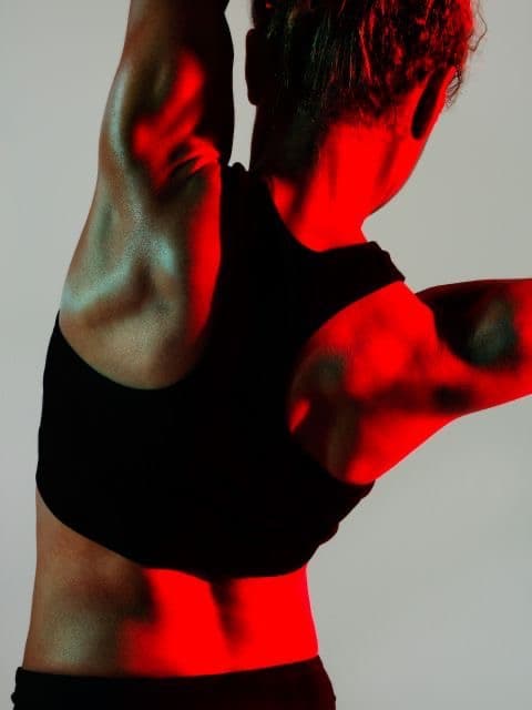 Shoulder and back in motion, lit in infrared red