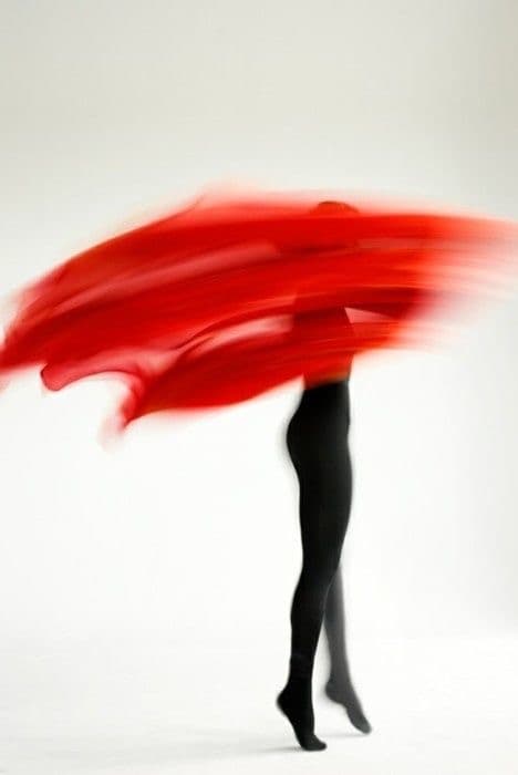 Red fabric in motion, body in movement